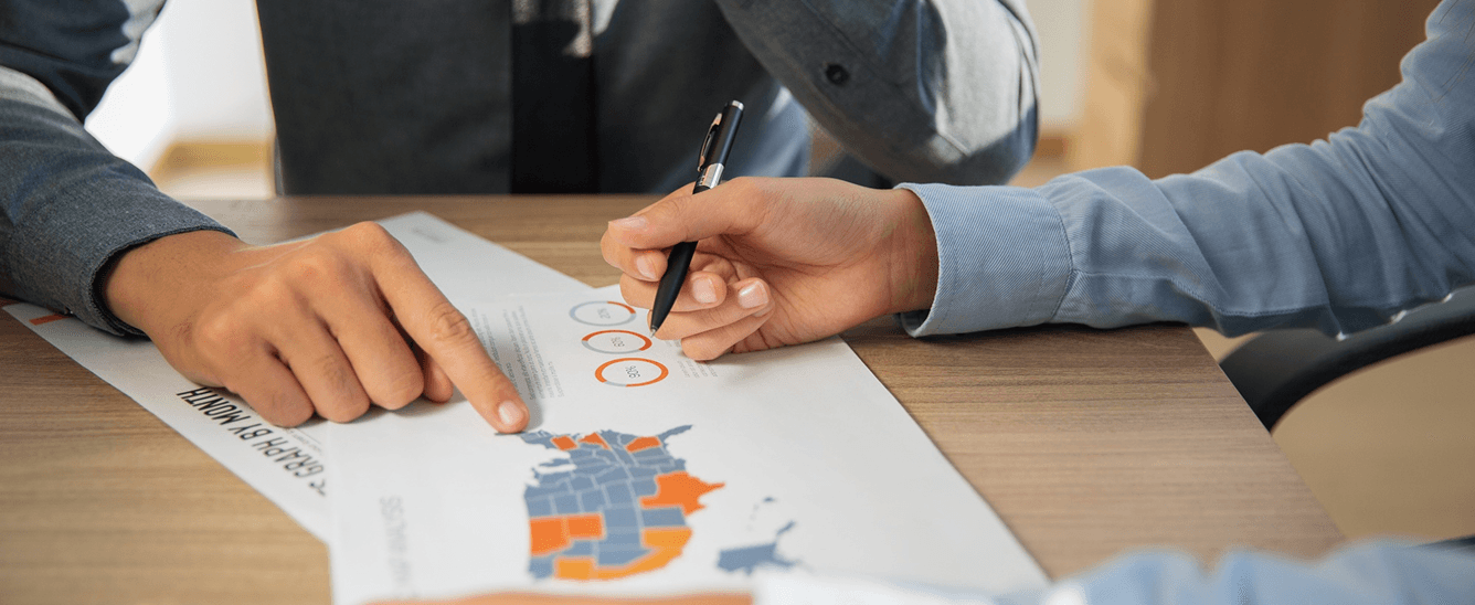 Two partners reviewing a sales territory map